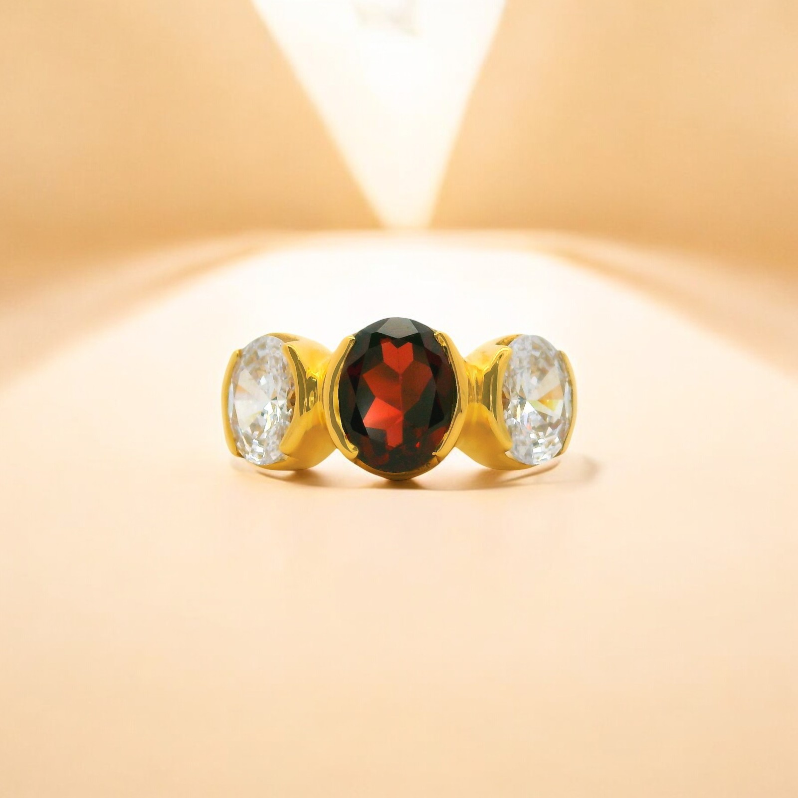 Gold Ring with Garnet and White Cubic Zirconia Trio Setting