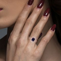 Sapphire Serenity: Rose Gold Ring with Single Blue Gem and Diamond Halo